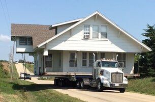 White Colored House Being Move Along the Road — House Lifting in Moundridge, KS