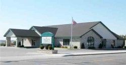 A funeral home with a flag in front of it.