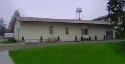 A large white building with a water tower on top of it.