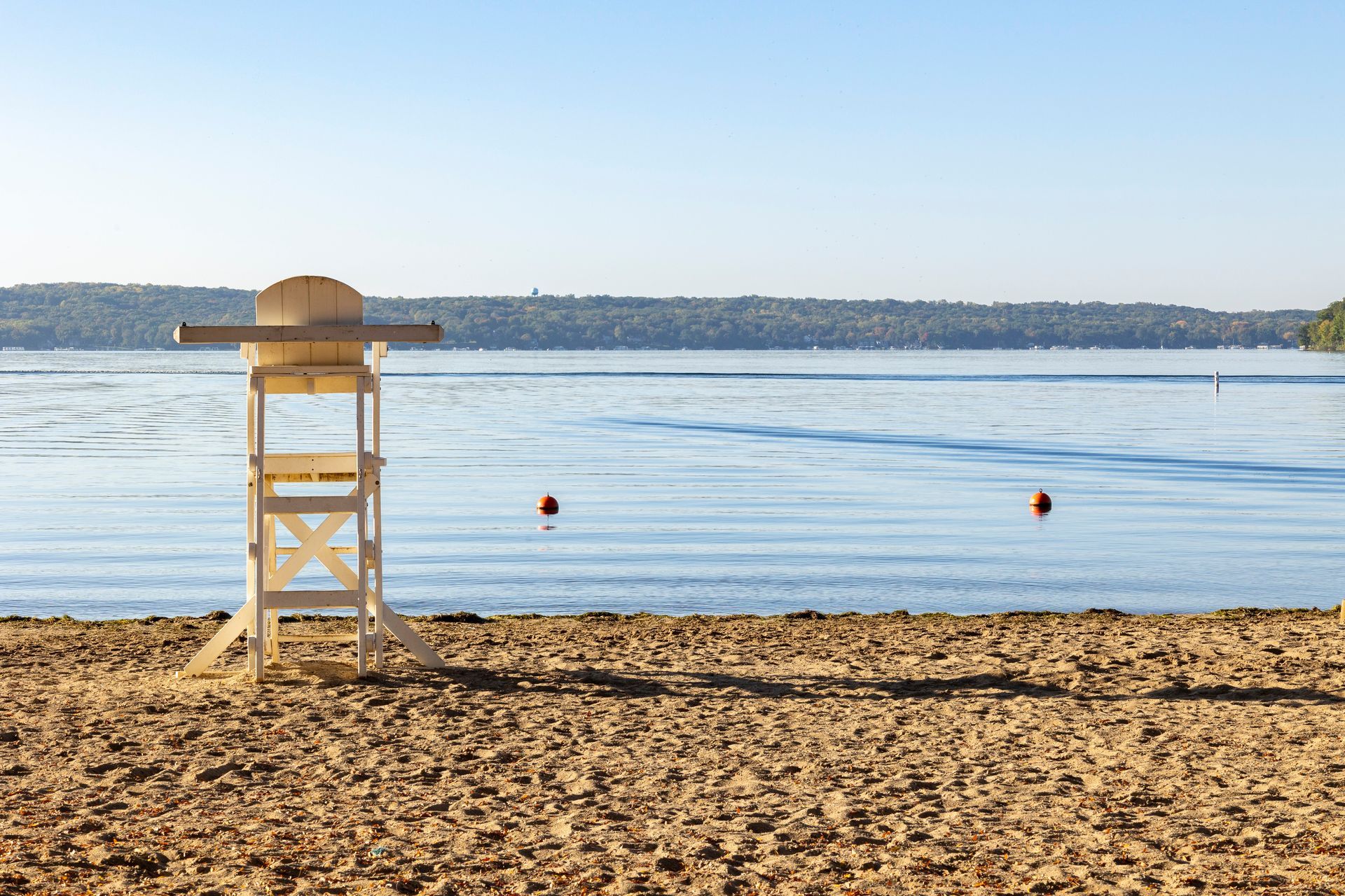 A lifeguard tower on a beach next to a body of water.