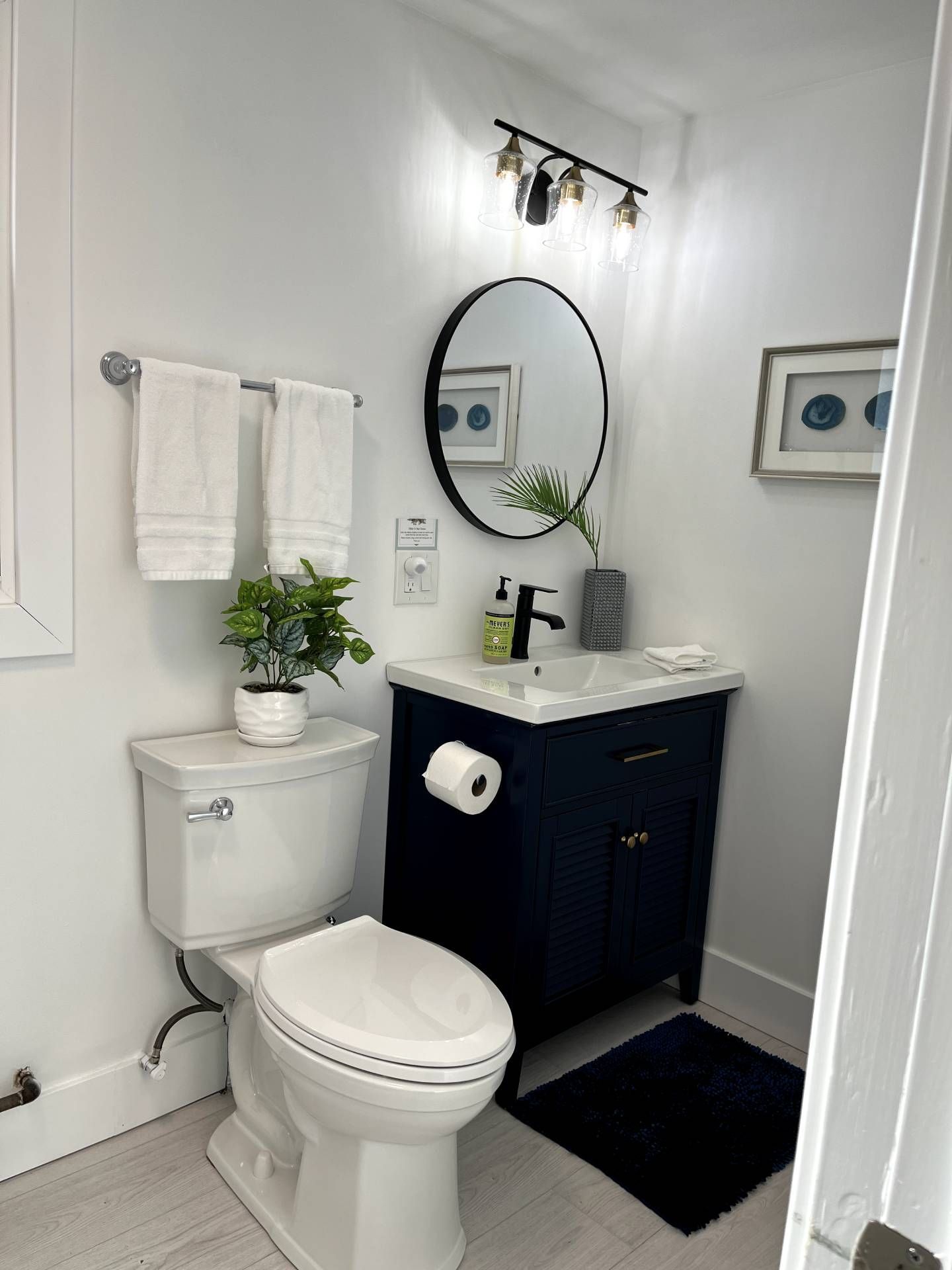 A bathroom with a toilet a sink and a mirror