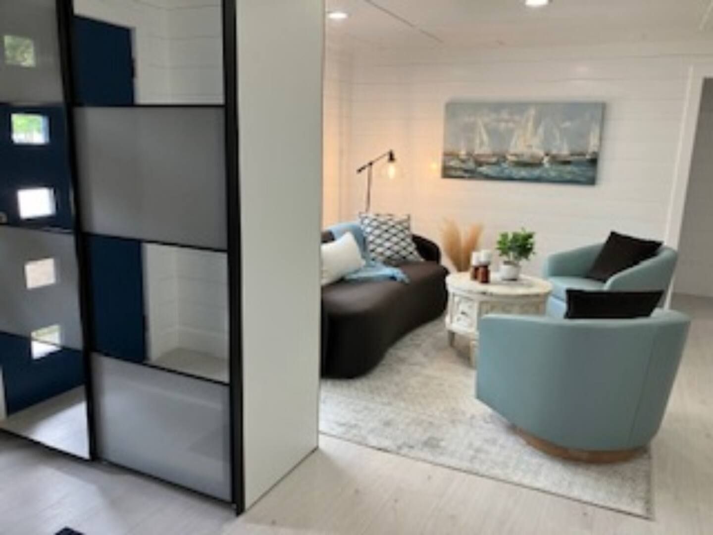 A living room with a couch and two chairs