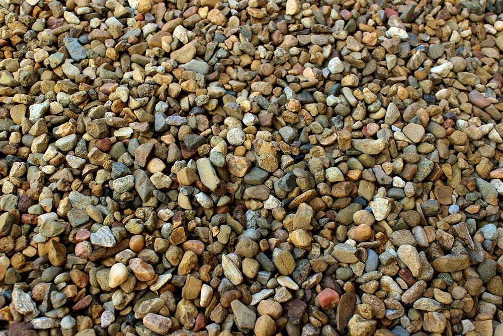 A Pile of Multi-Coloured River Rocks Sitting on Top of Each Other — Caloundra Landscape Supplies in Beerwah, QLD