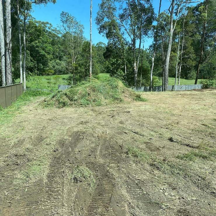 A Dirt Road Going Through a Field With Trees in the Background — Caloundra Landscape Supplies in Caloundra, QLD
