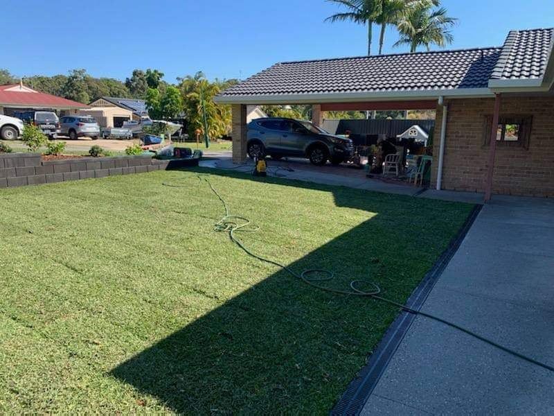 A Car is Parked in a Driveway in Front of a House — Caloundra Landscape Supplies in Caloundra, QLD
