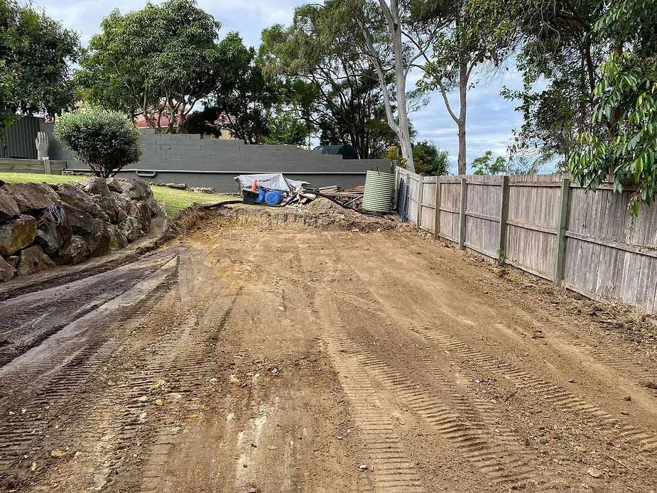 A Dirt Road With a Fence in the Background and a House in the Background — Caloundra Landscape Supplies in Caloundra, QLD