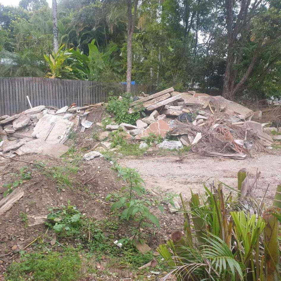 A Pile of Wood is Sitting in the Middle of a Dirt Field — Caloundra Landscape Supplies in Caloundra, QLD