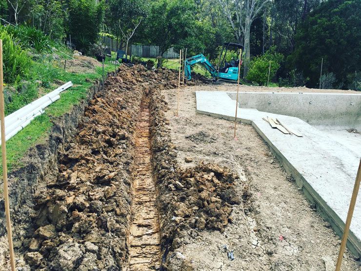 A Large Pile of Dirt is Sitting Next to a Pool — Caloundra Landscape Supplies in Caloundra, QLD