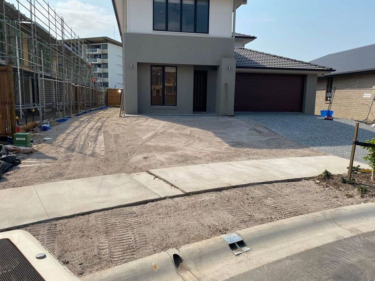 A House is Being Built Next to a Sidewalk and a Driveway — Caloundra Landscape Supplies in Caloundra, QLD
