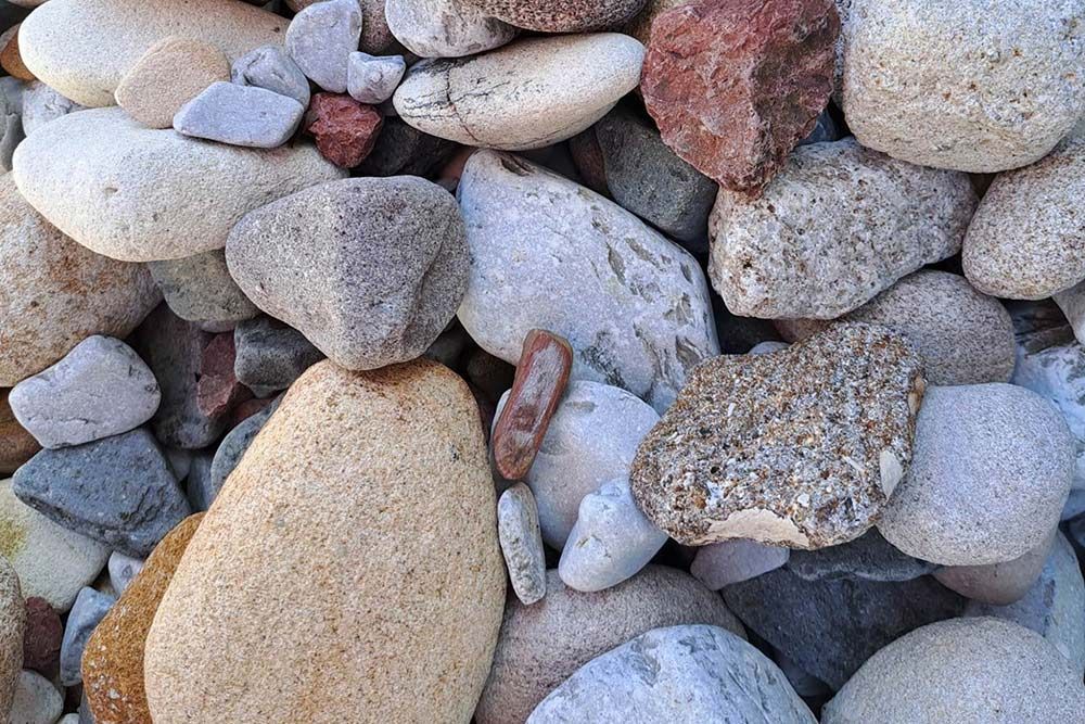 A Pile of Rocks of Different Sizes and Colors Are Stacked on Top of Each Other — Caloundra Landscape Supplies in Beerwah, QLD