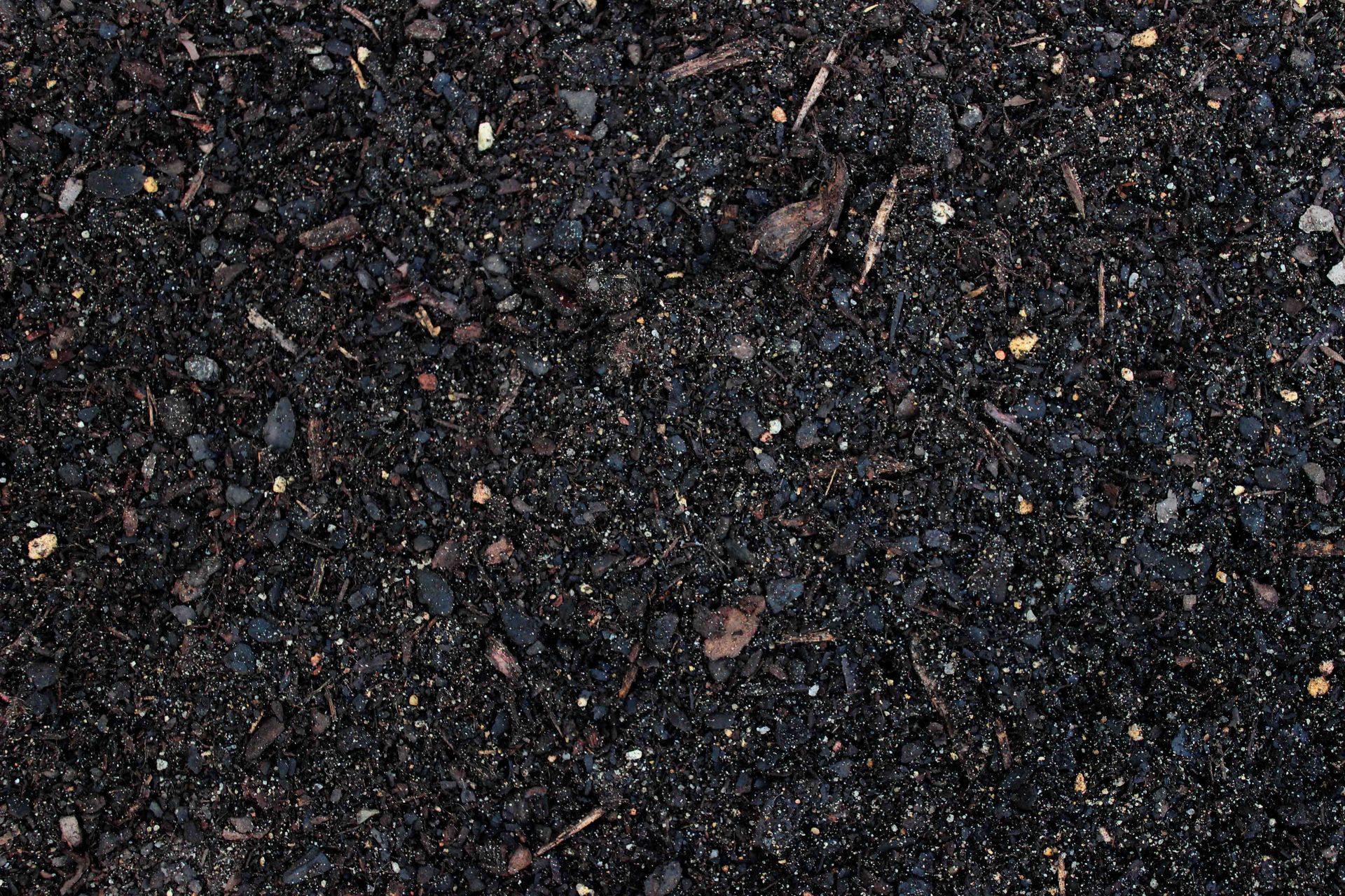 A Pile of Black Dirt With a Lot of Small Stones in It — Caloundra Landscape Supplies in Caloundra, QLD
