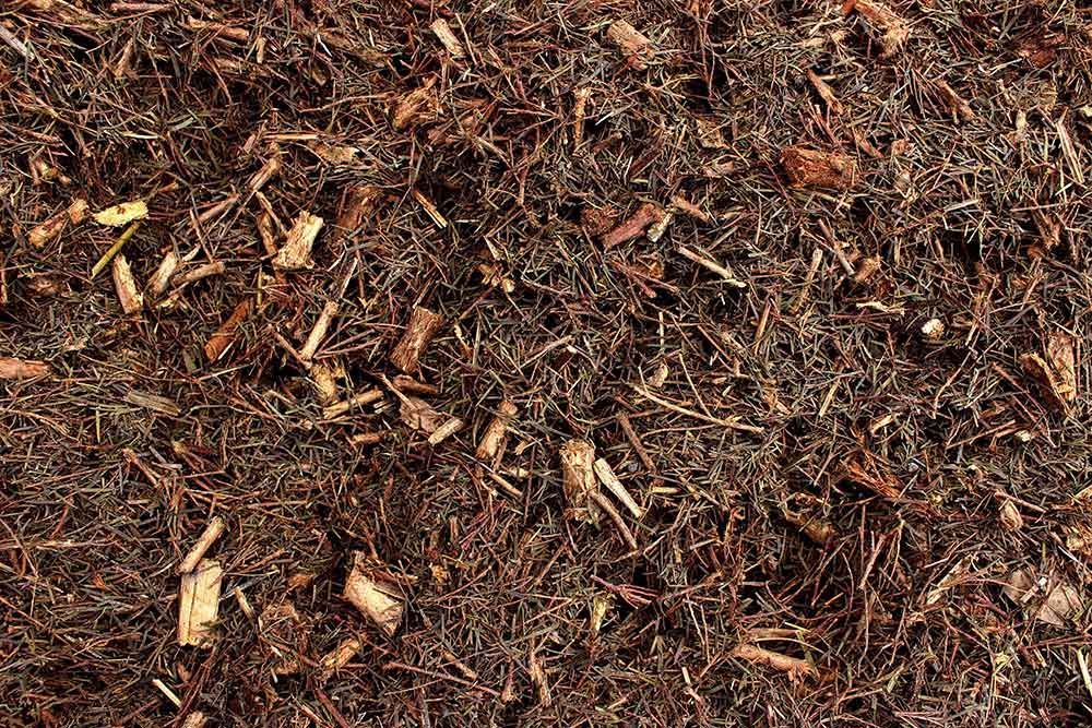 A Pile of Brown Mulch With a Lot of Wood Chips in It — Caloundra Landscape Supplies in Beerwah, QLD
