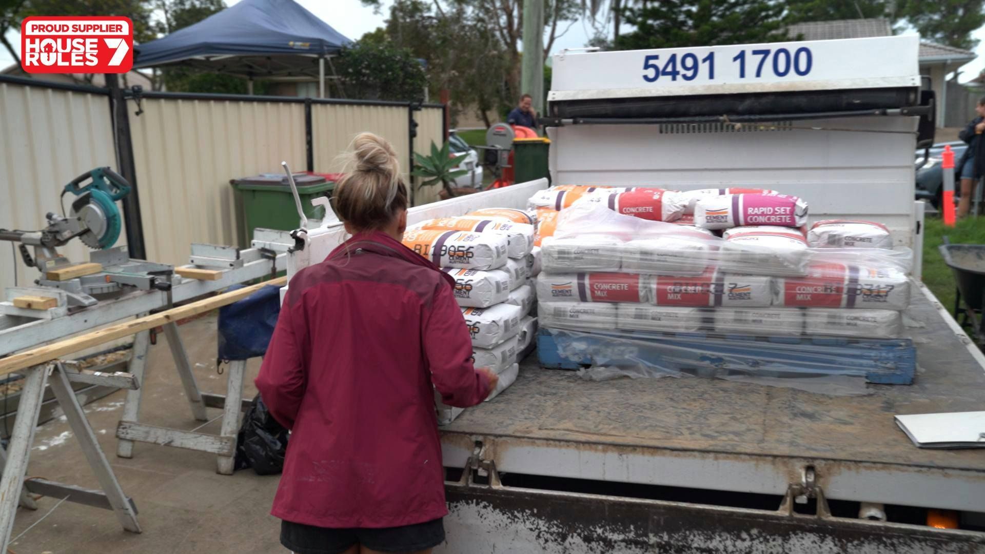 A Blue Wheelbarrow With the Word Built on It — Caloundra Landscape Supplies in Caloundra, QLD