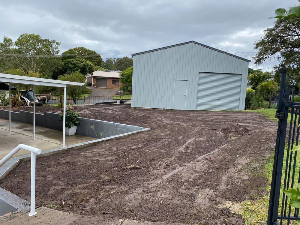 A White Building is in the Middle of a Dirt Field — Caloundra Landscape Supplies in Caloundra, QLD