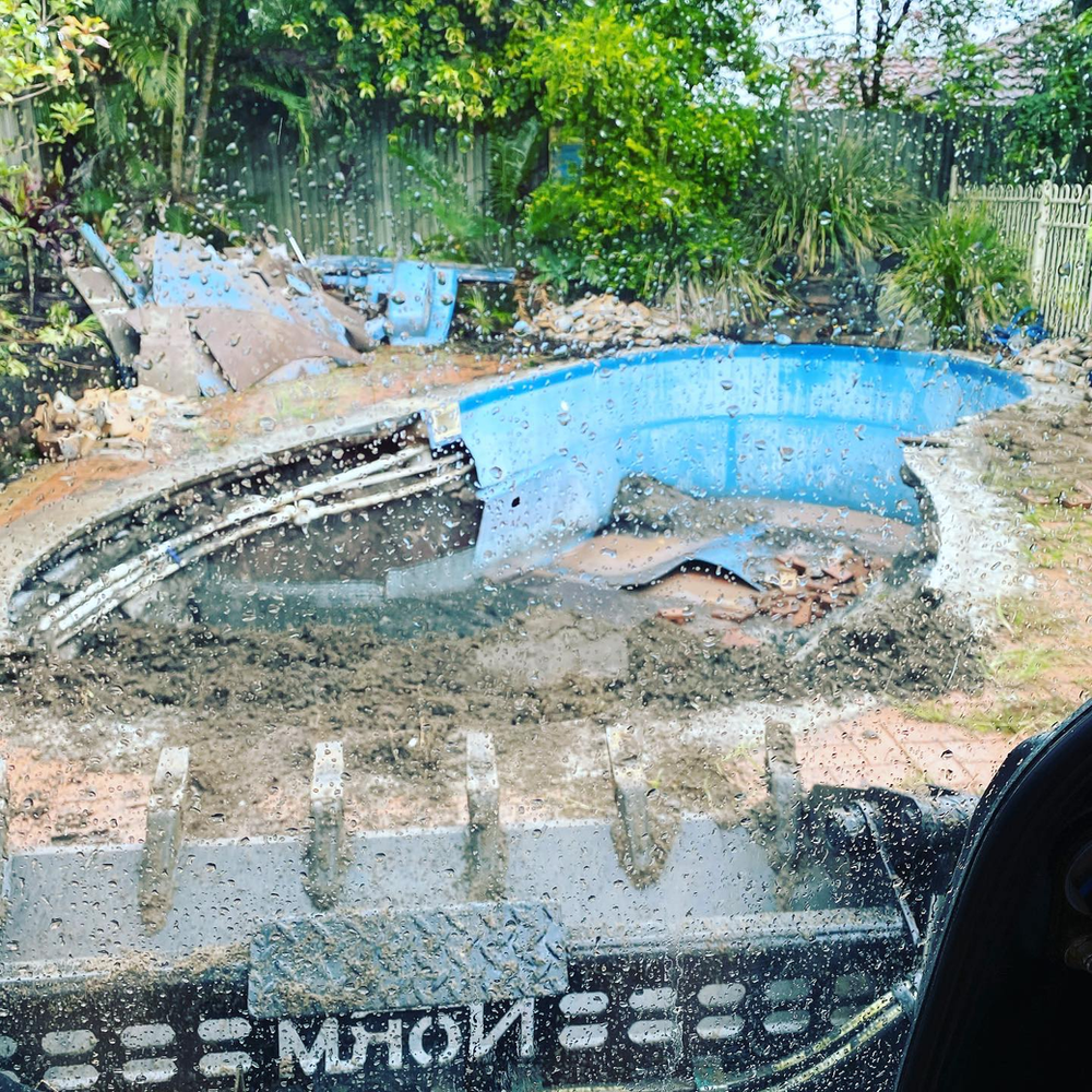 A Large Blue Pool is Being Built in a Backyard — Caloundra Landscape Supplies in Caloundra, QLD