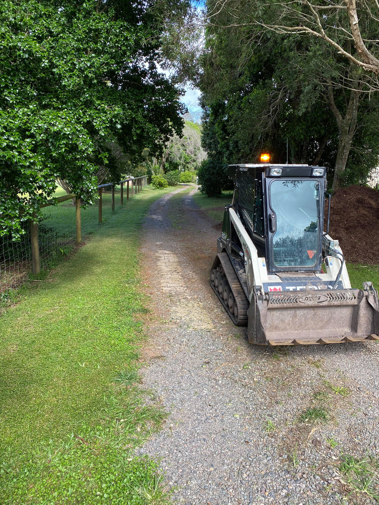 A Bulldozer is Parked on the Side of a Gravel Road — Caloundra Landscape Supplies in Caloundra, QLD
