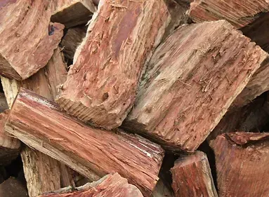 A Pile of Chopped Wood is Sitting on Top of Each Other — Caloundra Landscape Supplies in Warana, QLD