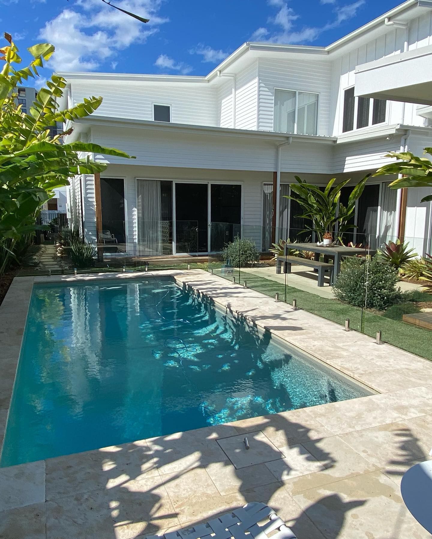A Bottle of Exceed Lawn Fertilizer With a Green Hose Attached to It — Caloundra Landscape Supplies in Caloundra, QLD