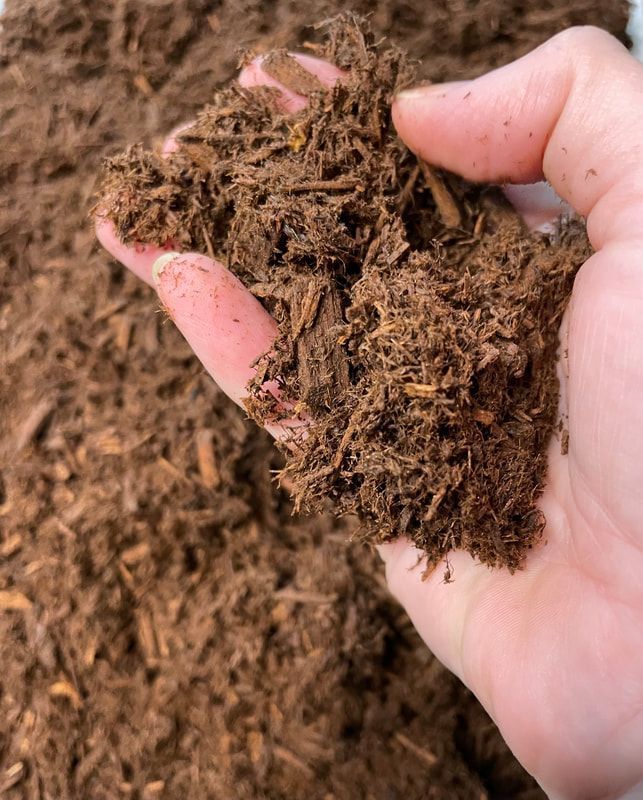 A Pile of Wood Chips and Leaves is Sitting on the Ground — Caloundra Landscape Supplies in Caloundra, QLD