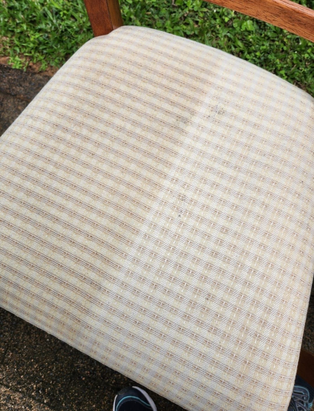 A Chair With a Striped Cushion is Sitting on the Ground — NQW Services In Cardwell, QLD