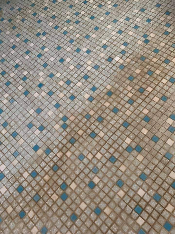 A Tiled Bathroom Wall Being Cleaned — NQW Services In Cardwell, QLD