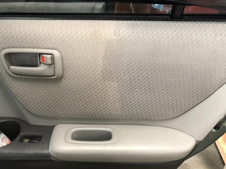 A Close Up of a Car Door With a Handle and a Cup Holder — NQW Services In Ingham, QLD