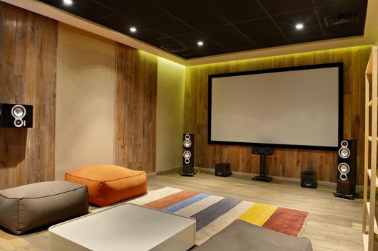 A home theater with a large screen and speakers.