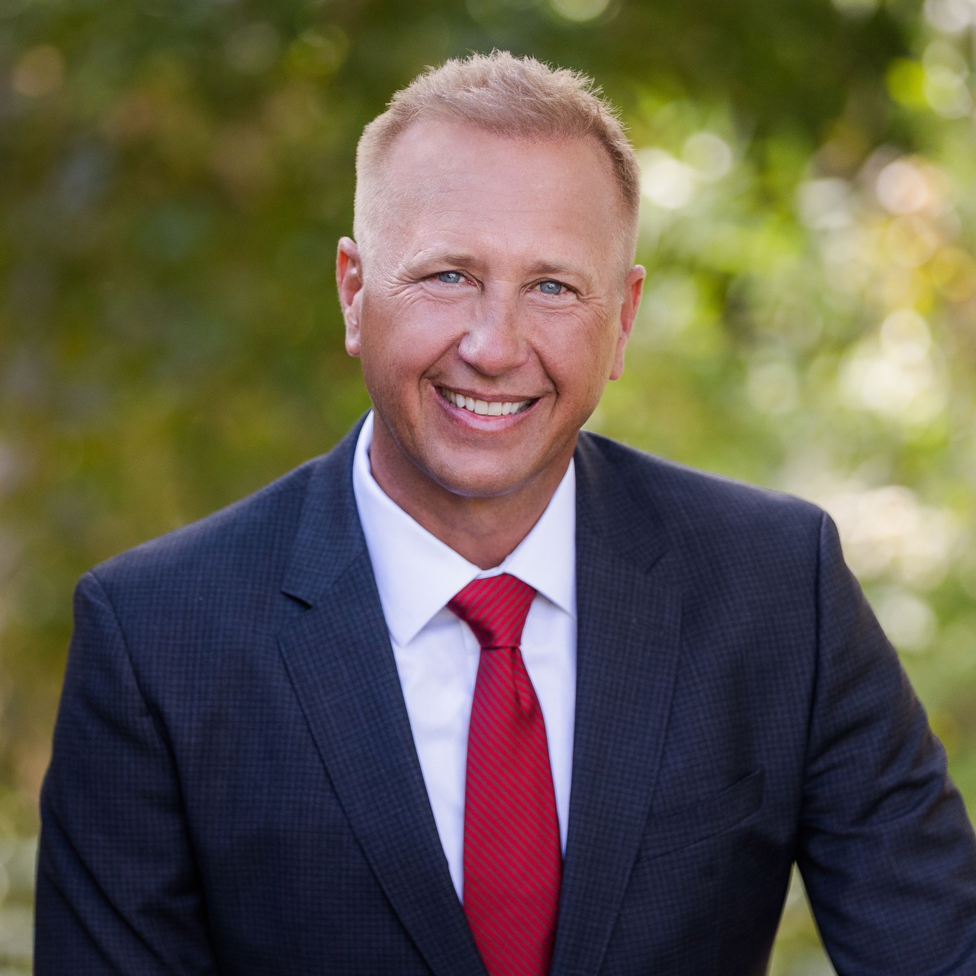 Outdoor, professional headshot of Rich Day in a suit and tie.
