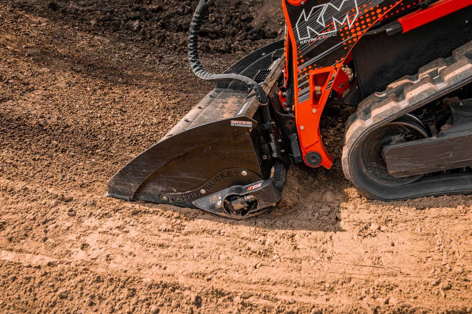 Side-by-side comparison of a standalone power rake and a CMP Hydra-Bucket.