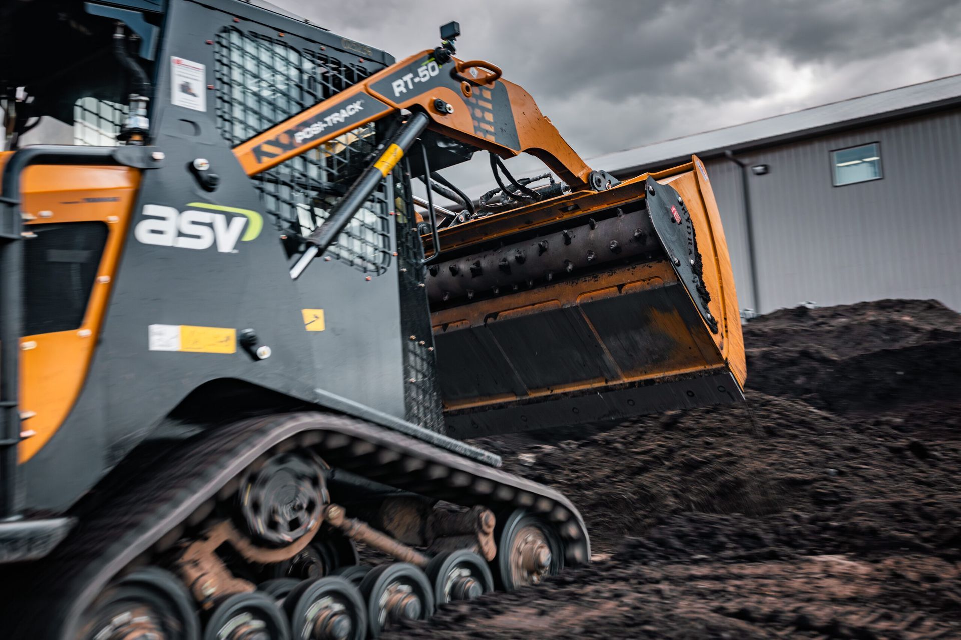 Skid steer maneuvering a compact Hydra-Bucket in a tight Northern Virginia backyard.