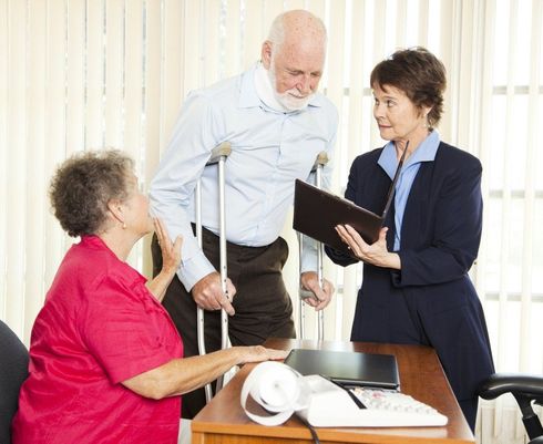 Personal Injury — An Old Man With His Wife Consulting An Attorney After Having An Auto Accident in Visalia, CA