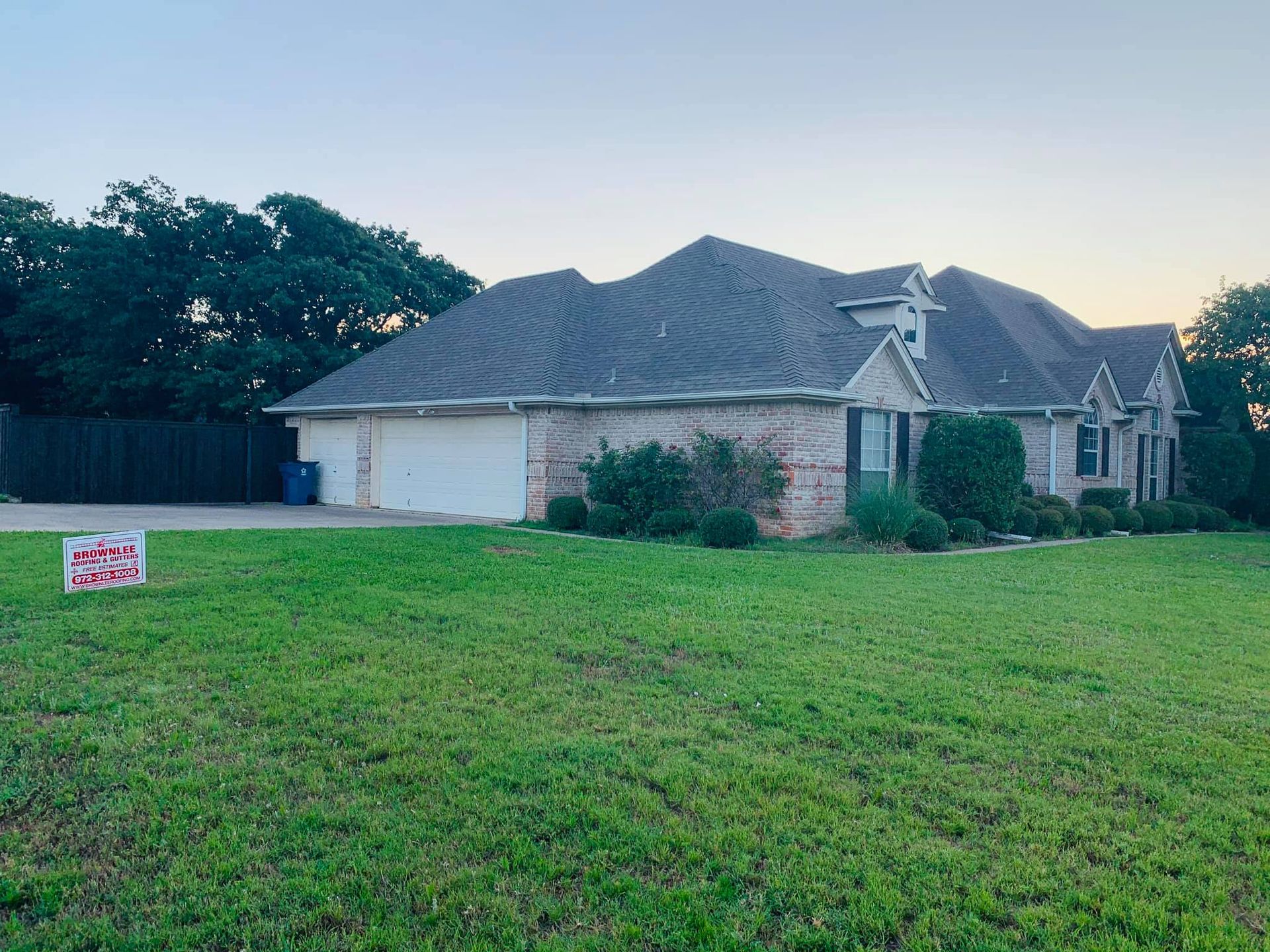 A large house with a for sale sign in front of it