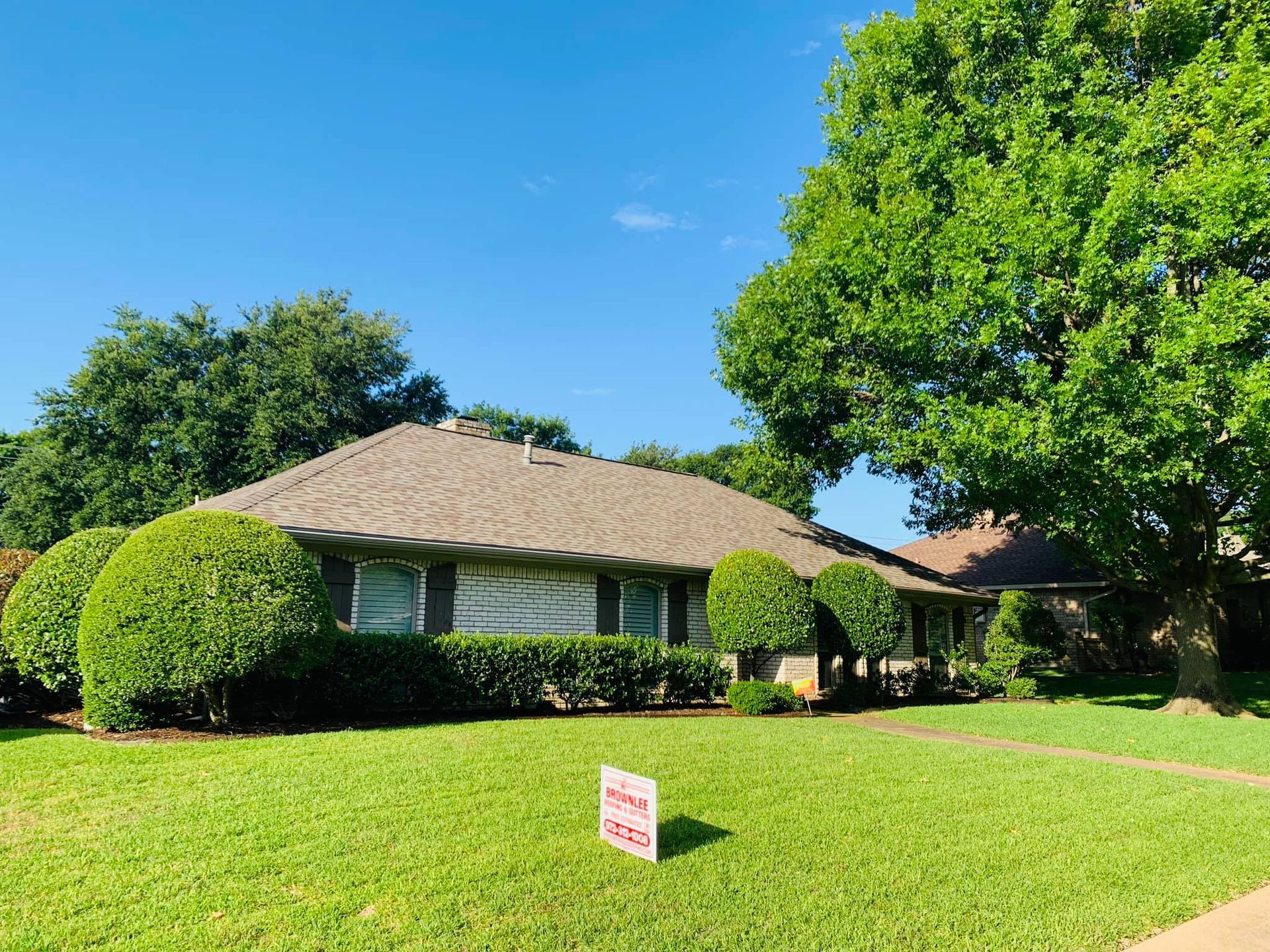 A house with a for sale sign in front of it.