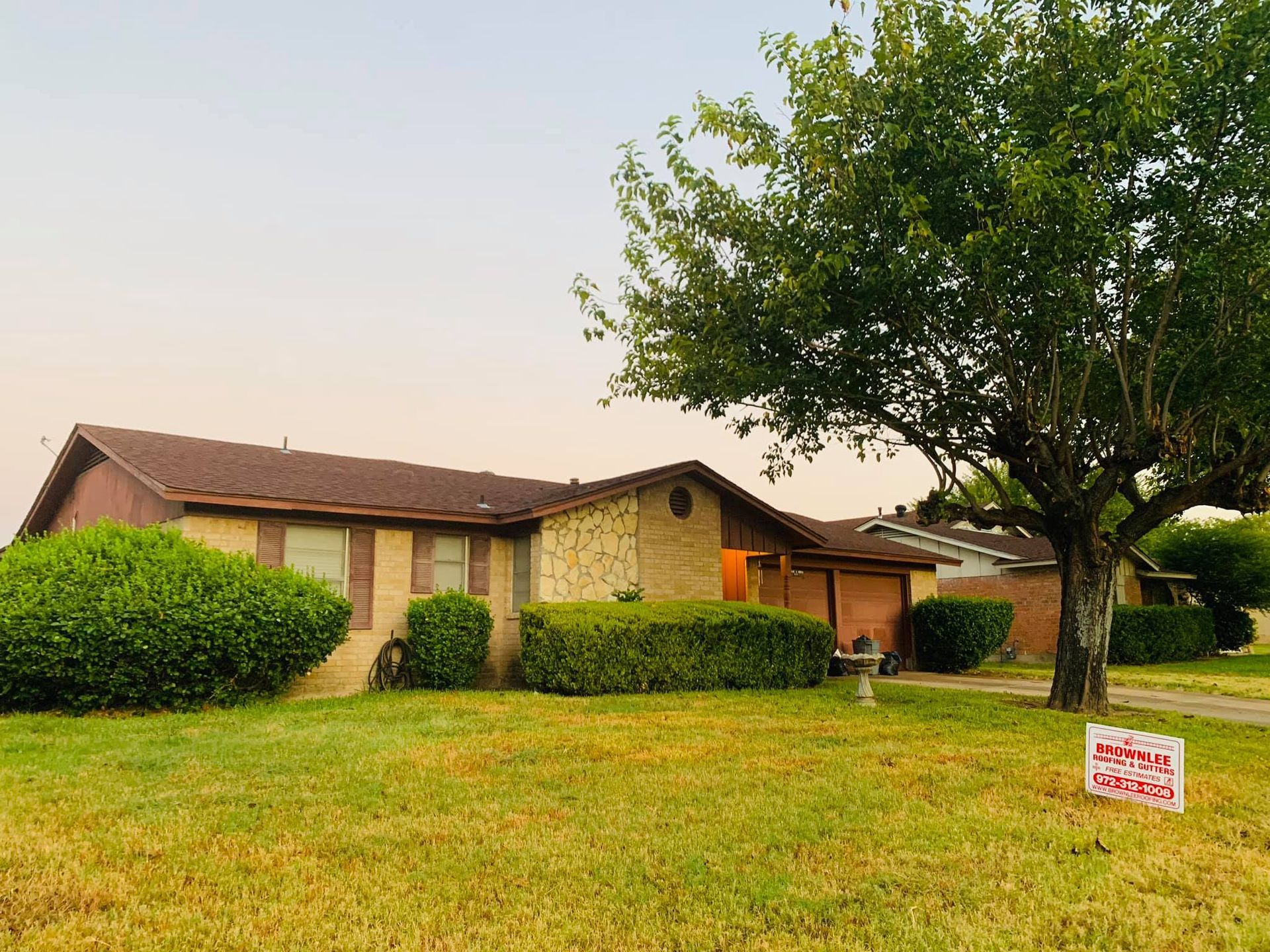 A house with a for sale sign in front of it