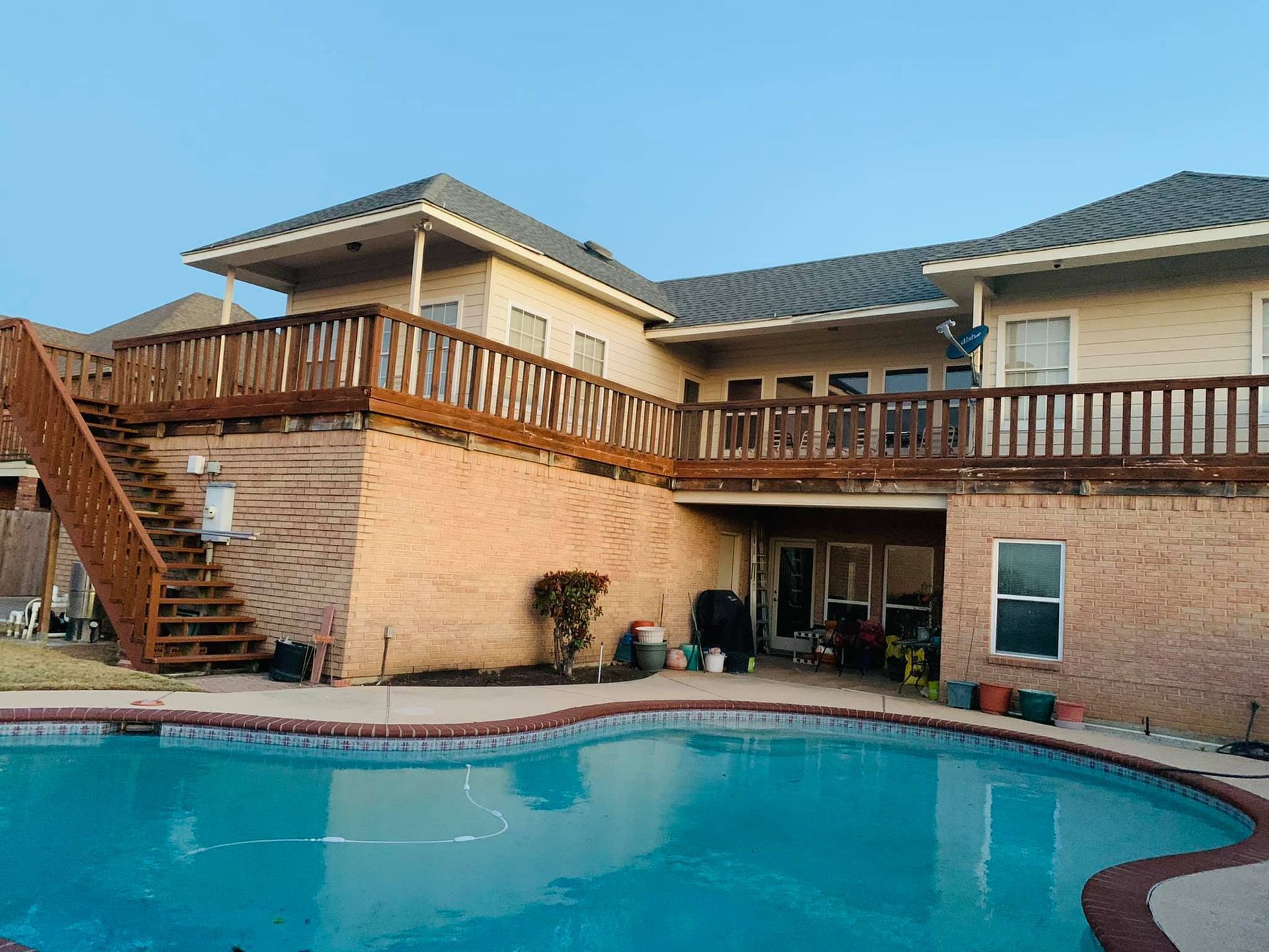 A large house with a large swimming pool in front of it
