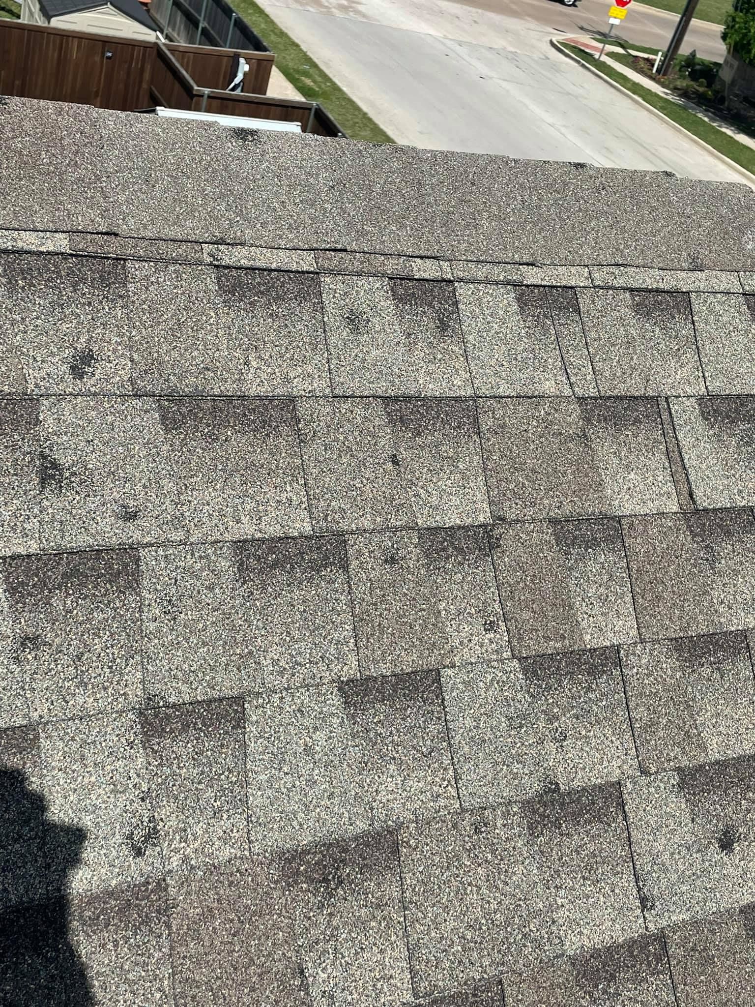 A close up of a roof with a lot of shingles on it.