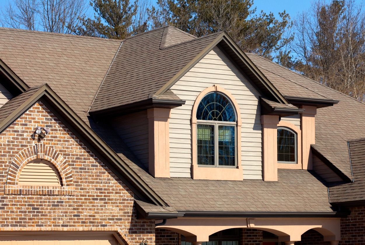 A large brick house with a large window on the roof