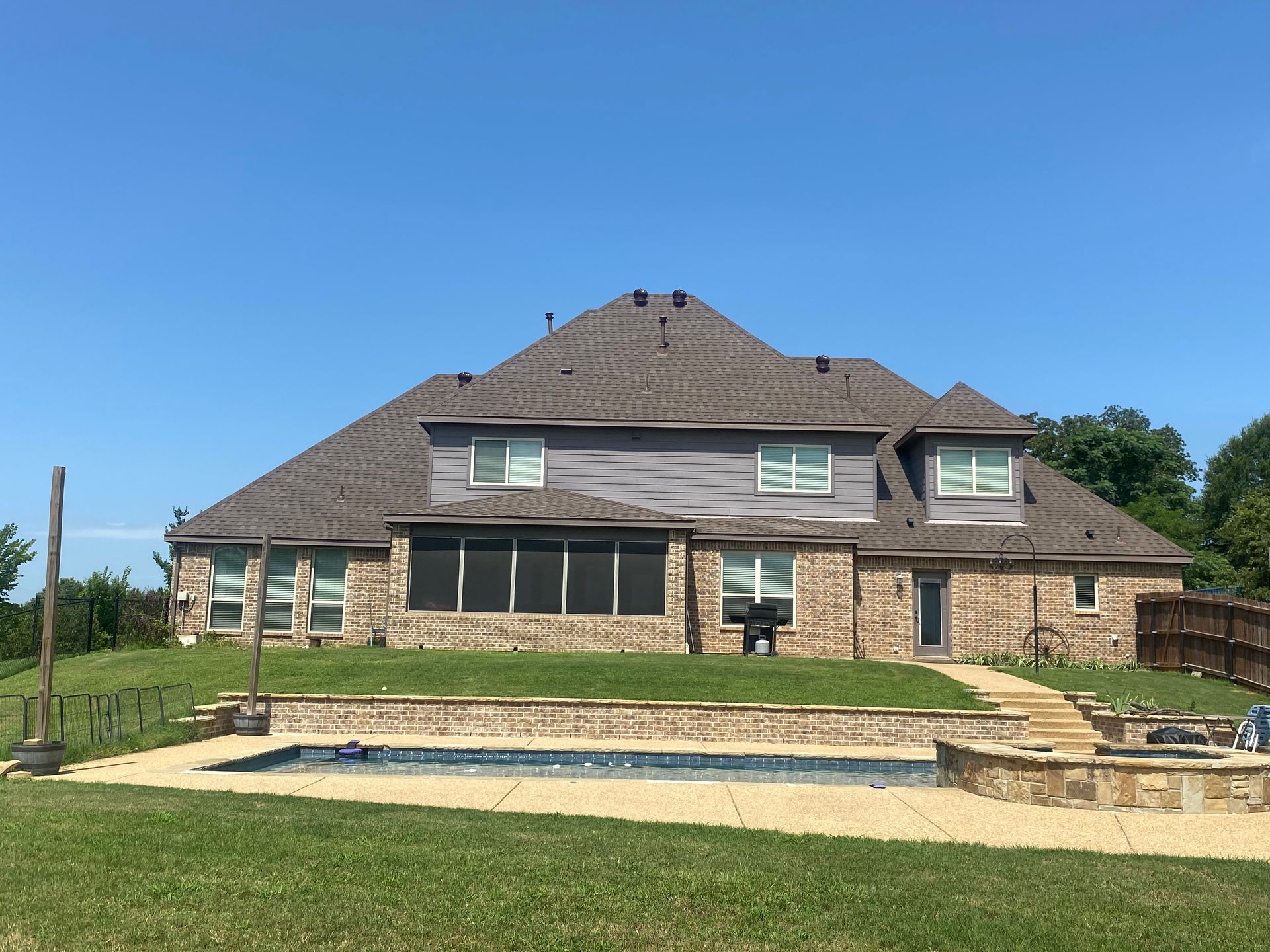 A large brick house with a tree in front of it