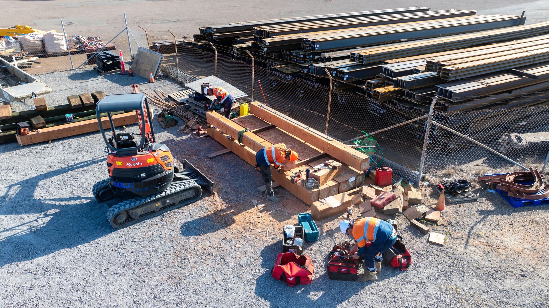 Construction Crew Members in High-Visibility Vests Work on Timber Beams — M&J Marine Services in Coffs Harbour, NSW