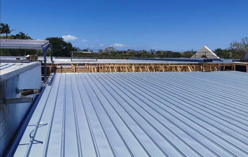 A Large Metal Roof With A Blue Sky In The Background — Kosick Roofing NQ Pty Ltd In Mount Low, QLD