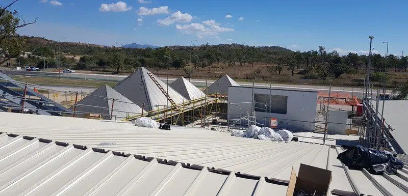 The Roof Of A Building Under Construction With Pyramids In The Background — Kosick Roofing NQ Pty Ltd In Mount Low, QLD