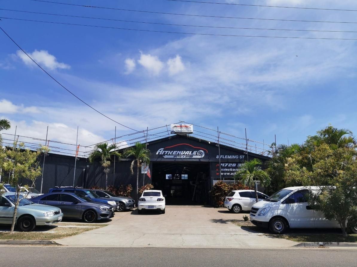 A Lot Of Cars Are Parked In Front Of A Building — Kosick Roofing NQ Pty Ltd In Mount Low, QLD