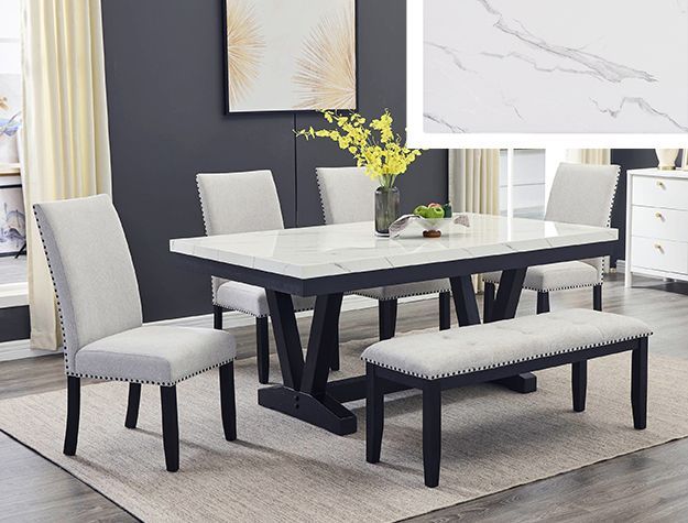 A dining room with a table and chairs and a bench.