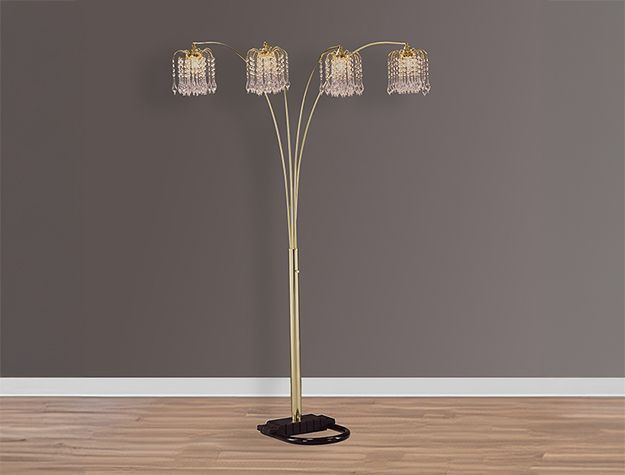 A floor lamp is sitting on a wooden floor in a room.