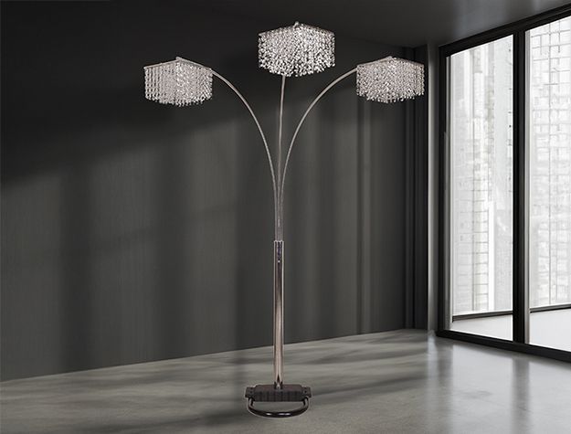 A floor lamp is sitting in a room next to a window.