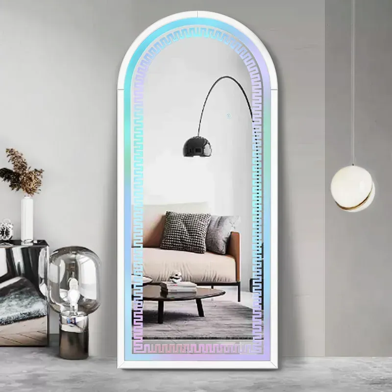 A living room with a full length mirror and a couch.