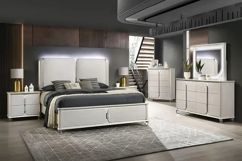 A bedroom with a bed , dresser , nightstand , mirror and rug.