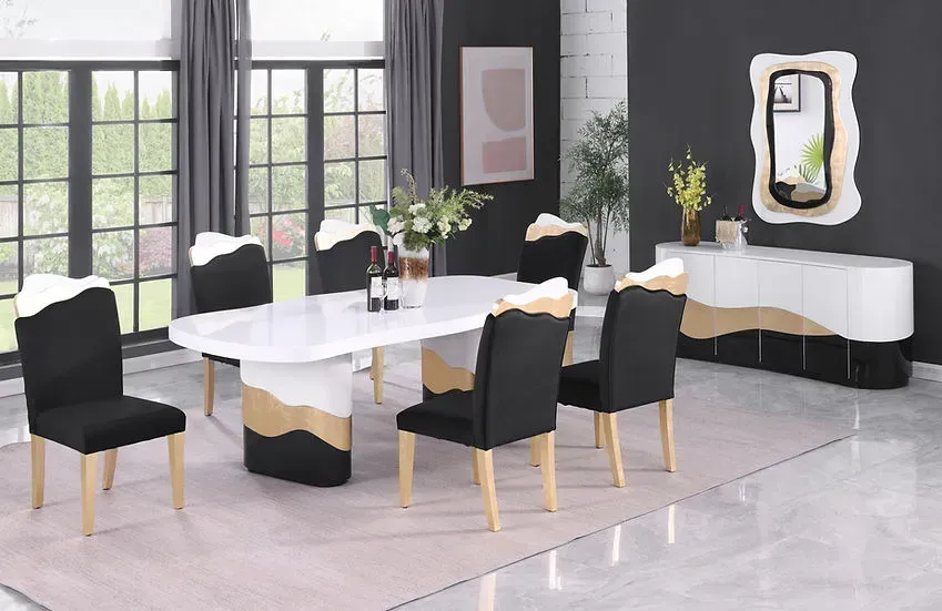 A dining room with a table and chairs and a mirror.