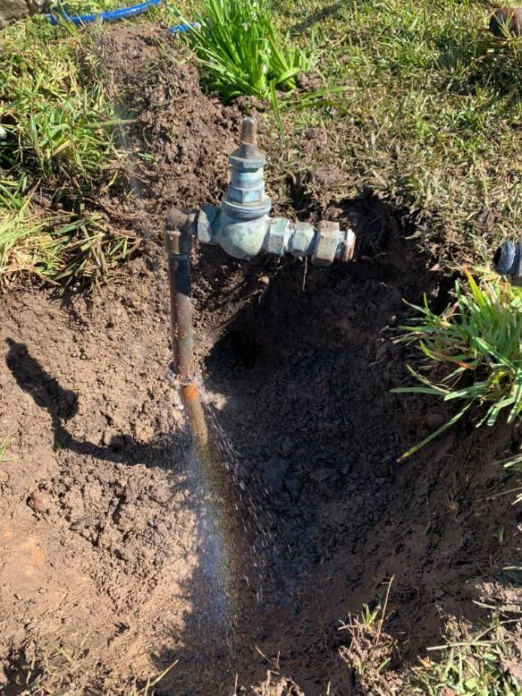 A Faucet Is Sitting In The Dirt In The Middle Of A Field — Oceanforce Plumbing In Blacksmiths, NSW