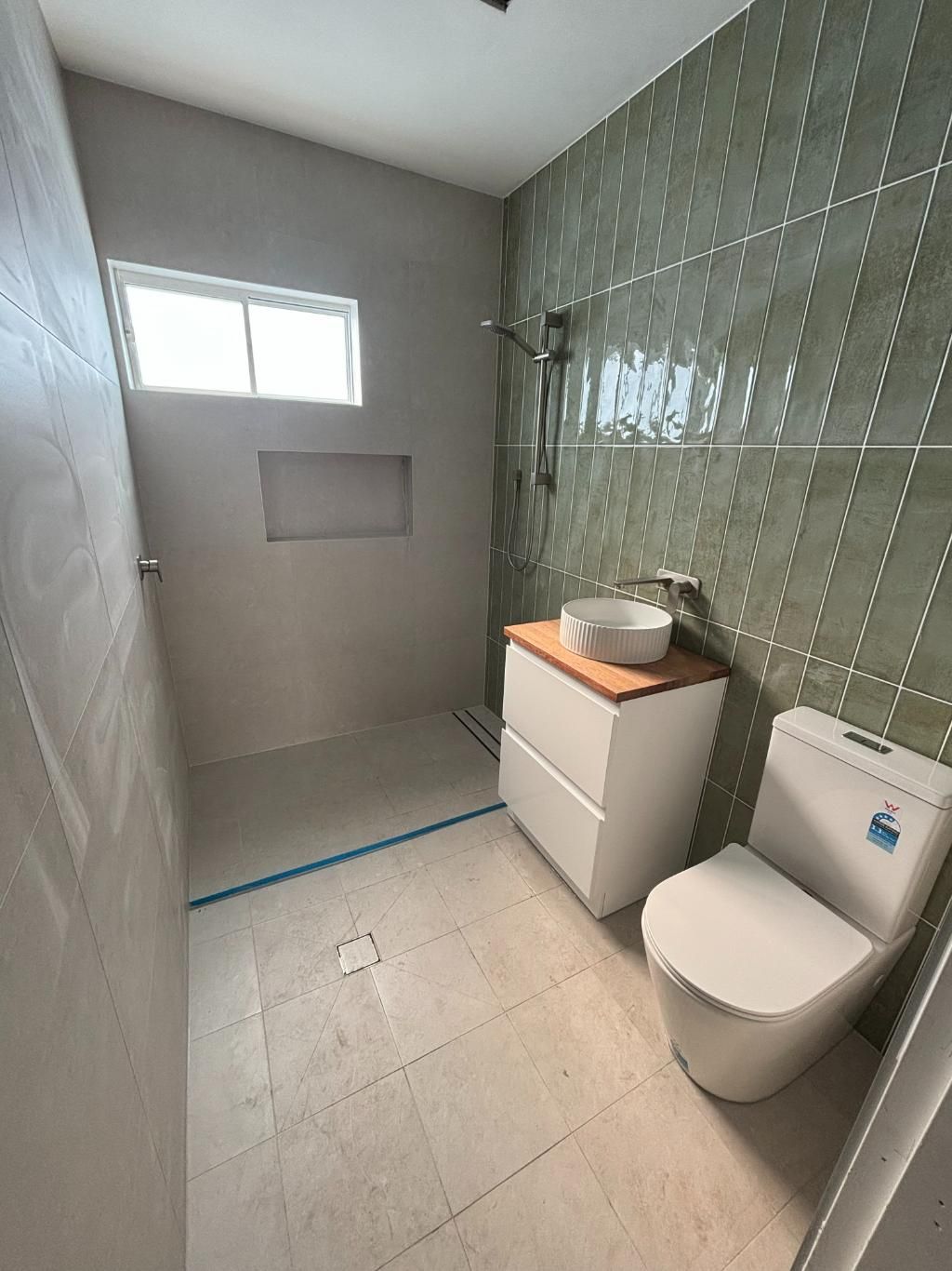 A Bathroom With A Toilet, Sink And Shower — Oceanforce Plumbing In Newcastle, NSW
